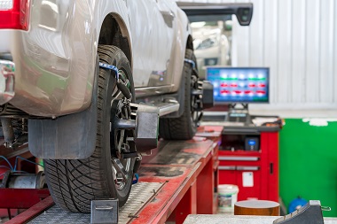 car having an alignment done with the computer specs in the background